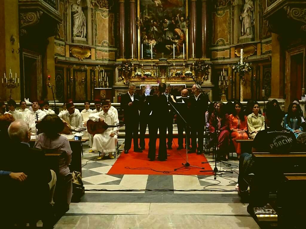 Gregorian choir and Andalusian ensemble performing together in a Roman church.