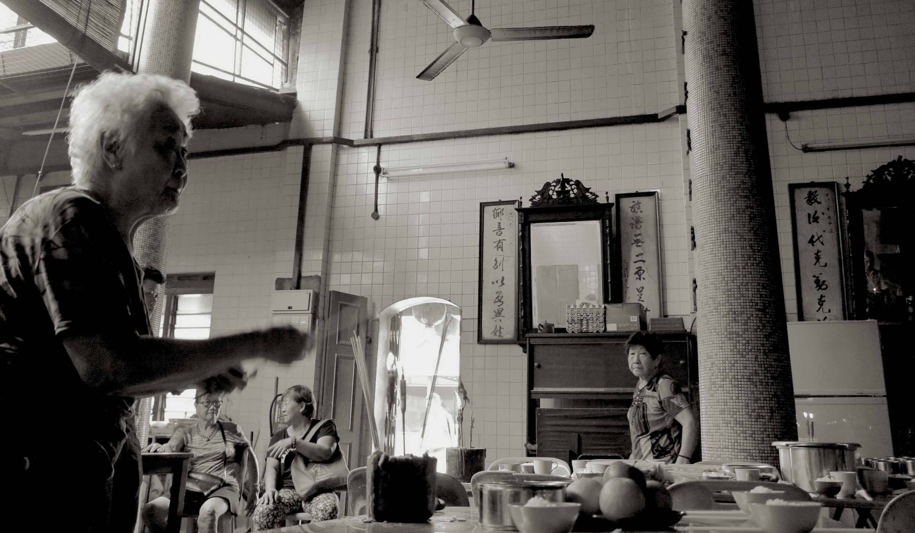 Incense smoke rising and dispersing across a temple doorway, photographed as part of the research process.