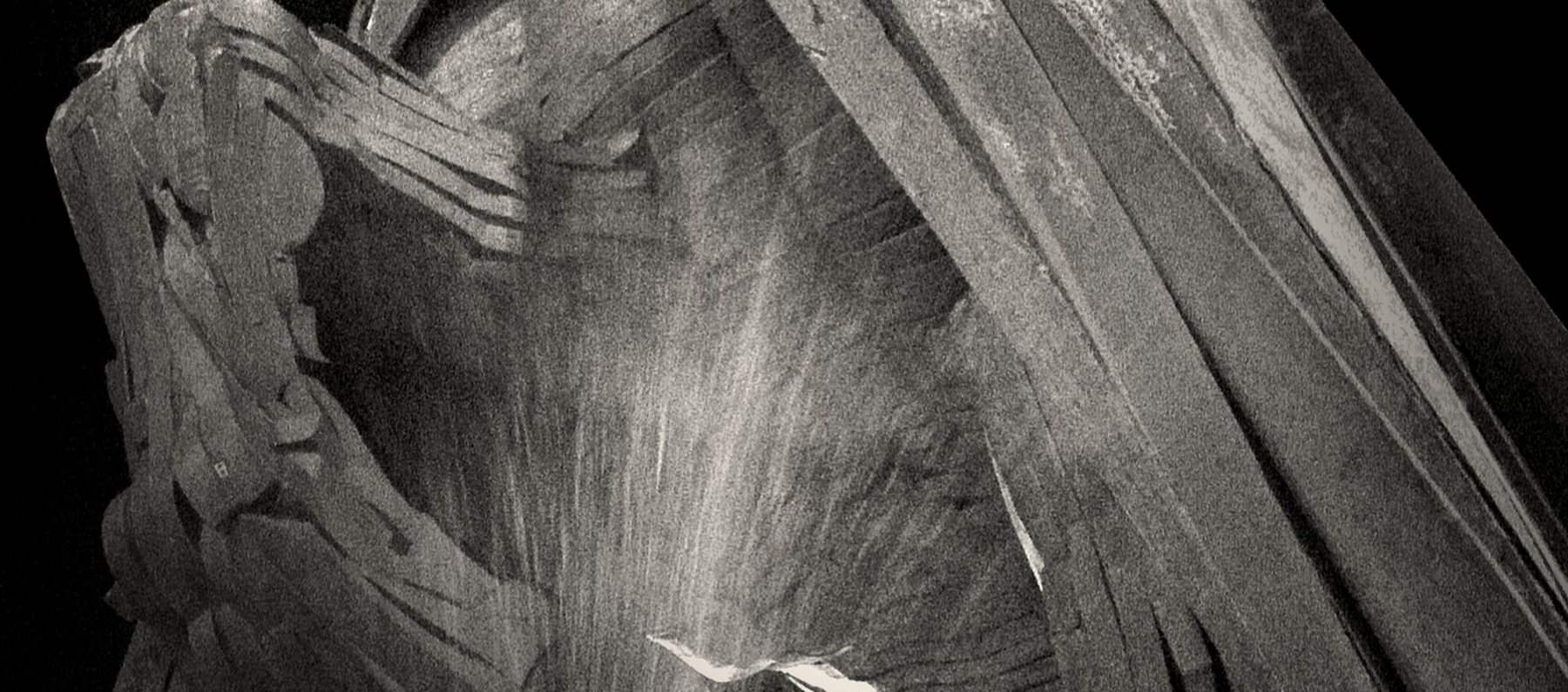 Folds of drapery, lit from one side, read as strata.